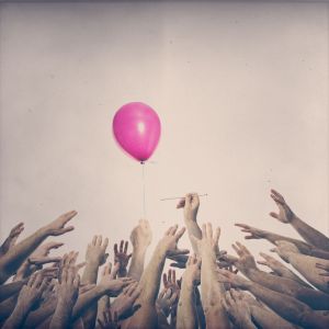 Das Bild des Fotografen Fritz Philipp aus Frankfurt mit den Thema Flüchtlingskrise zeigt viele Hände die alle nach einem Luftballon greifen
